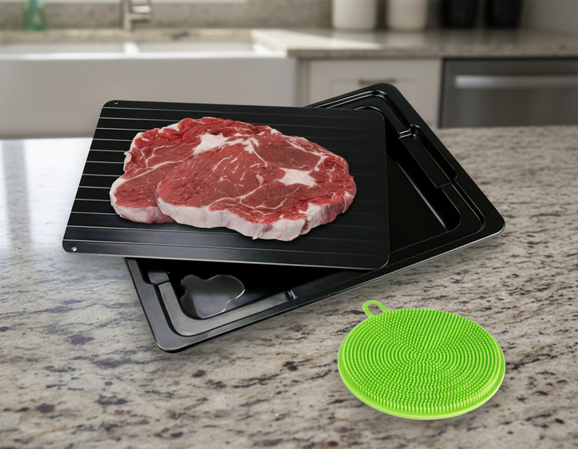 Raw steak on a black grill mat with a green silicone mat on a white background