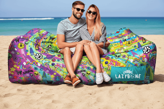 Two people sitting on a colorful bean bag with Chillbo Lazybone branding, surrounded by related products.